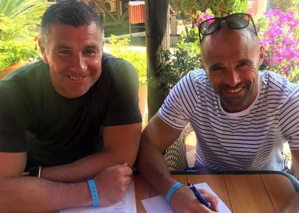 Richie Barker and Paul Warne sign their new three-year deals with Rotherham United while on holiday