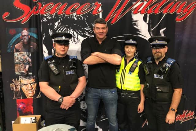 The force is strong as Darth Vader star Spencer Wilding poses for a fun photo with officers from South Yorkshire Police force.
