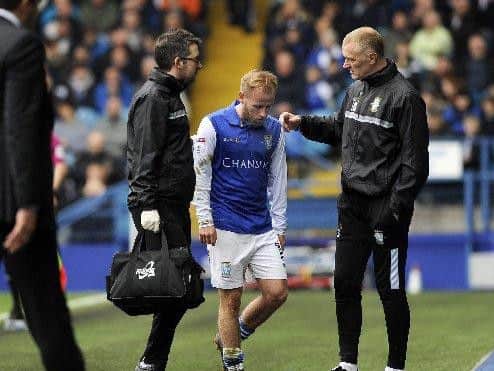 Barry Bannan shows his disappointment at going off injured last term.