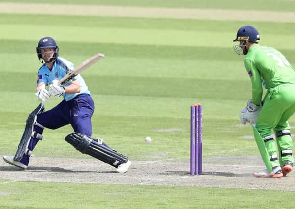 Yorkshire's Adam Lyth hits out from the bowling of  Lancashire's Matthew Parkinson watched by wicket keeper Dane Vilas.