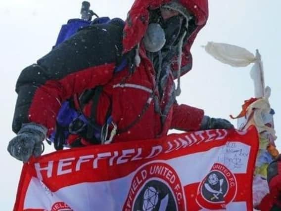 Ian planted a Sheffield United flag at the summit to boost his fundraising total, despite being a devoted Owls fan.