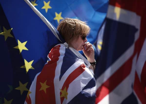 An anti-Brexit demonstrator looks pensive during a protest outside the Houses of Parliament on June 11, 2018 . The EU withdrawal bill returns to the House of Commons tomorrow for the first of two sessions in which MP's will consider amendments imposed by the Lords, and another set of fresh amendments.  (Photo by Dan Kitwood/Getty Images)