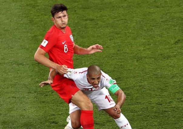 England's Harry Maguire and Tunisia's Wahbi Khazri (right) battle for the ball during the FIFA World Cup Group G match at The Volgograd Arena, Volgograd.