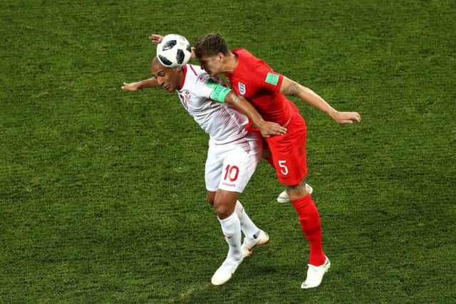 Tunisia's Wahbi Khazri and England's John Stones, right, battle for the ball during the FIFA World Cup Group G match at The Volgograd Arena, Volgograd.