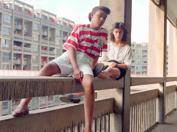 Bill Stephenson, Donna Hargreaves and Carmen Bello sit on an unguarded fourth storey concrete parapet. Hyde Park Flats, Sheffield, 1988  Bill Stephenson