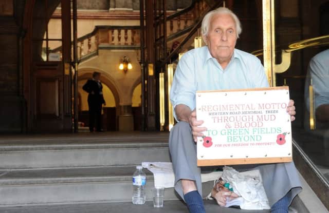 Roy Parkin has been protesting on the Sheffield Town Hall about the plans to the fell Western Road memorial trees. Picture: Andrew Roe