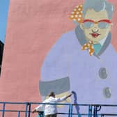 Sheffield artist Pete McKee works on 'Muriel' a new mural on the side of the Art House on Carver Street.