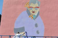 Sheffield artist Pete McKee works on 'Muriel' a new mural on the side of the Art House on Carver Street.