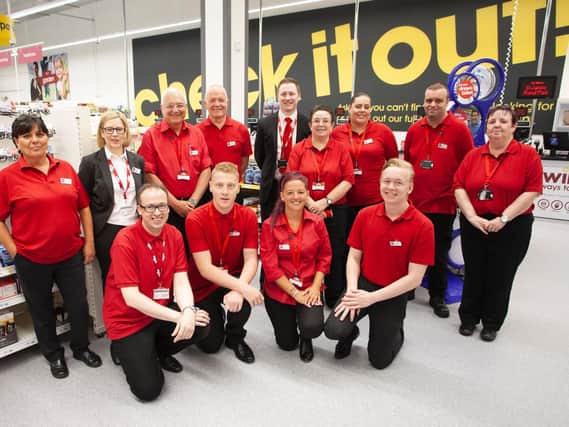 Staff at the new store celebrate the opening.