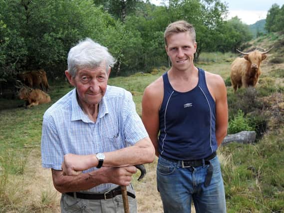 Farmers, Alex with his Grandfather, David, at the Baslow Edge site where their Highland cattle are grazing.