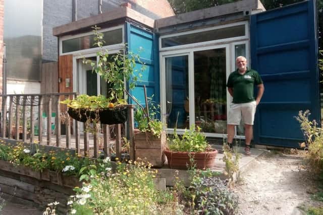 REACH Homes founder Jon Johnson outside the prototype shipping container where he has been living at Heeley City Farm