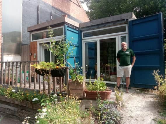 REACH Homes founder Jon Johnson outside the prototype shipping container where he has been living at Heeley City Farm