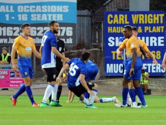 Fernando Forestieri goes to ground after an altercation with Mansfield's Krystian Pearce