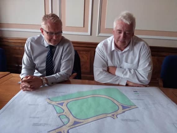 Green light: Council transport director Paul Castle and highways group manager Ian Wilson examine plans for the road scheme at the Dodworth Road bottleneck.