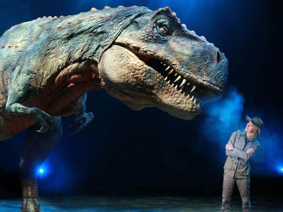 Michaela Strachan with themighty 22ft tall Tyrannosaurus Rex
