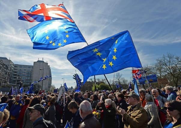 Placards and flags are held by pro-EU protesters taking part in a March for Europe rally against Brexit in central London.