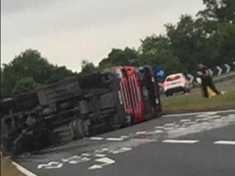 Two firefighters were trapped in their engine when it overturned this morning