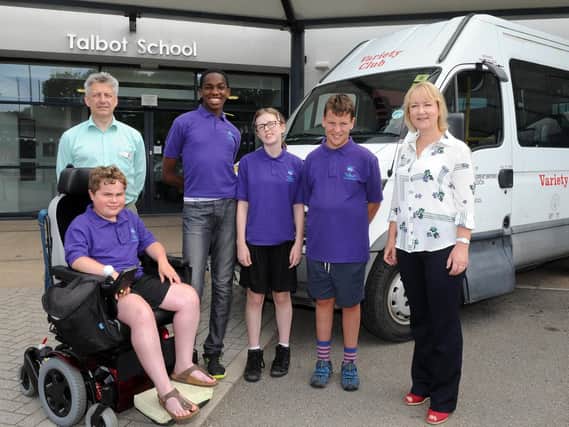 Headteacher Carolyn Sutcliffe and assistant headteacher and driver Nigel Kirkpatrick with pupil from Talbot Specialist School infront of their current minibus. Pictures: Andrew Roe