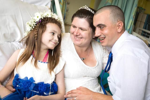 Cancer patient Kayleigh Walsh (left) with her parents Lyndsey and Paul Walsh, following their wedding blessing ceremony at Sheffield Children's Hospital (Picture:  Danny Lawson/PA Wire)
