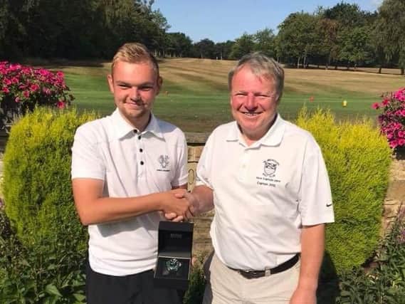 Jack Crisp and his dad Richard with the exclusive Hugo Boss watch he was awarded for sinking his second hole-in-one at Hillsborough Golf Club