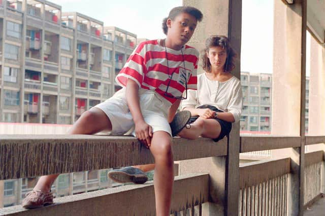 Donna Hargreaves and Carmen Bello sit on an unguarded fourth storey concrete parapet. Hyde Park Flats, Sheffield, 1988. Picture: Bill Stephenson