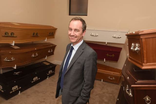 Adam Heath in the coffin showroom.