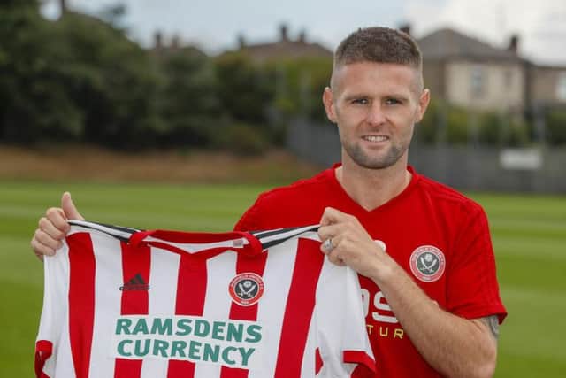 Oliver Norwood signs on loan ahead of a permanent deal in January.