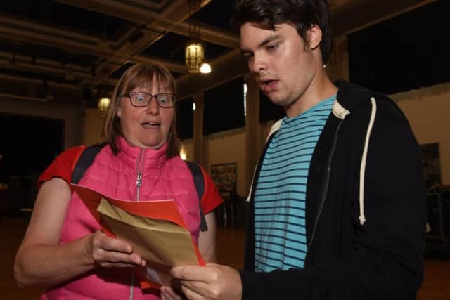 Robbie McGann, who achieved 2 A*s and an A, with his mum Julie with shock on their faces as they open his results on A Level results day at High Storrs School.