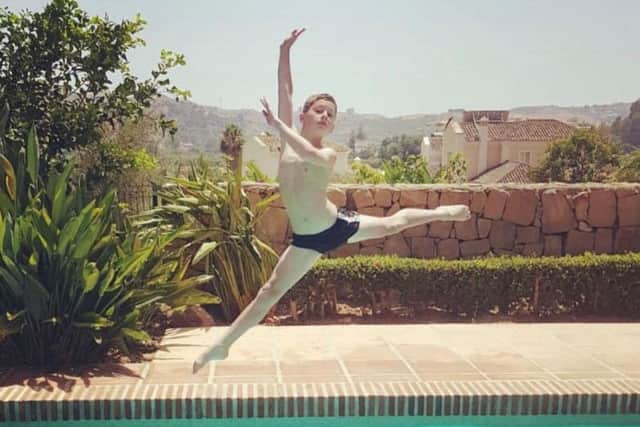 Young ballet dancer and diver Cameron Cinnamond-Bland combining his talents, practising an arabesque