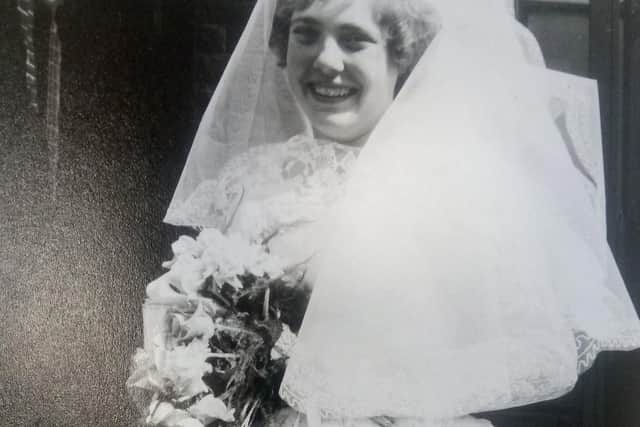 The mystery bride is all smiles on her big day.