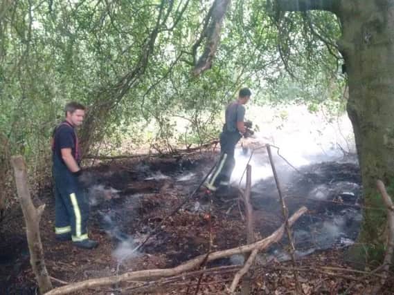 Firefighters douse the smouldering ground after a blaze at the Moss Valley Woodlands in Sheffield (pic: Nabil Abbas)
