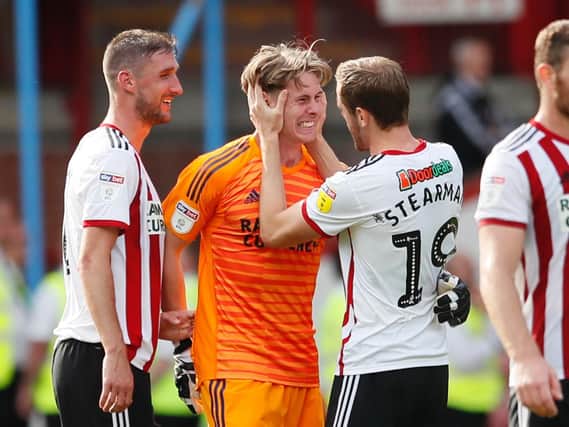 United goalkeeper Dean Henderson celebrates with Richard Stearman and Chris Basham after the Blades' win over Norwich City. Picture:Simon Bellis - Sport Image