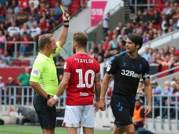 Bristol City's Matty Taylor receives a yellow card off referee Oliver Langford after fouling Middlesbrough's George Friend during the Sky Bet Championship match at Ashton Gate, Bristol. PA Picture