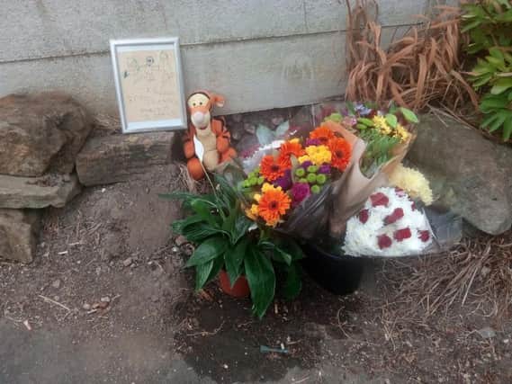 A cuddly Tigger toy and a drawing the victim had done as a young boy were left beside the floral tributes