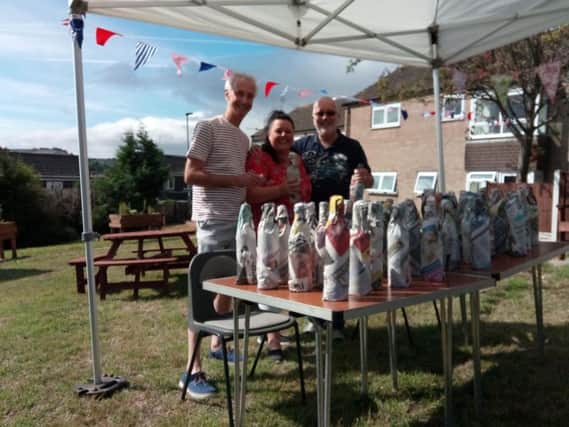 Success: Coun Dave Griffin, Helen Townsend and Bob Green, who all helped secure the future of Royds Community Garden lend a hand setting up stalls for the opening gala.