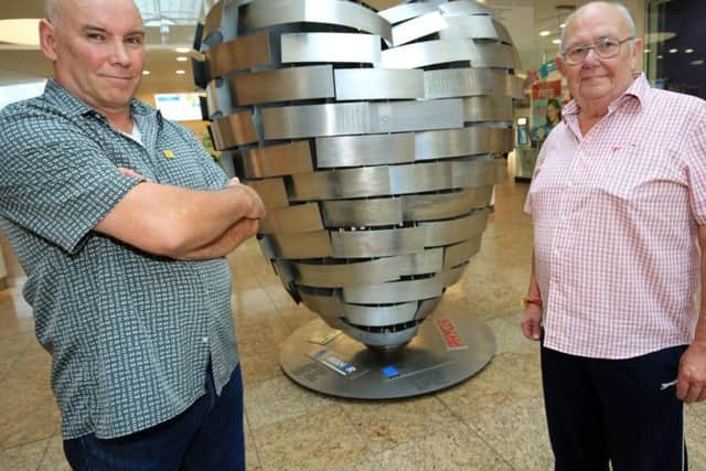 Artist Steve Mehdi and ex-steelworker Terry Mansell with the Heart of Steel sculpture at Meadowhall
