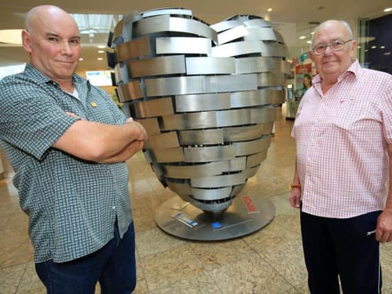 Artist Steve Mehdi and ex-steelworker Terry Mansell with the Heart of Steel sculpture at Meadowhall