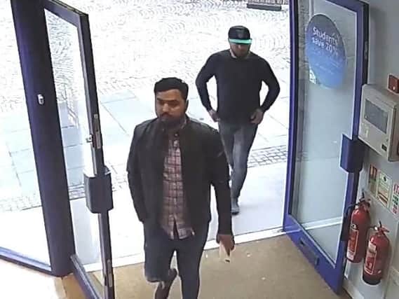 CCTV of two men entering the shop.