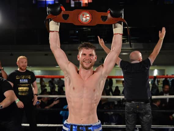 Lee Appleyard celebrates with the English lightweight title. Pic: Dean Woolley