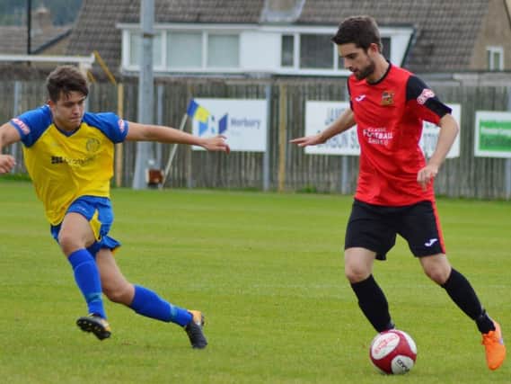 Sheffield FCs Jamie Gregory (red shirt) in action against Stocksbridge is a doubt for the visit of Pontefract due to a hamstring niggle Pic by Gillian Handisides