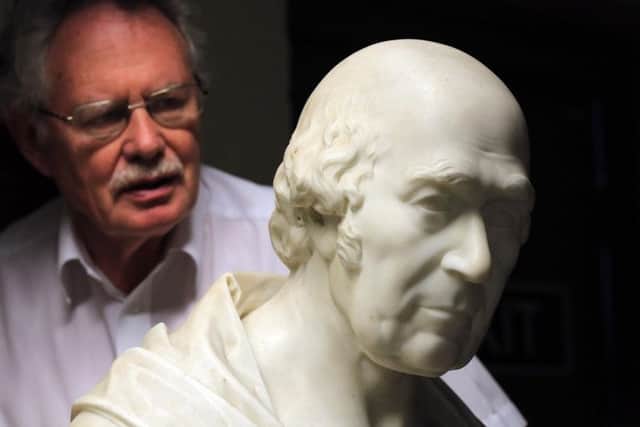 Dr Mike Collins with a bust of one of the hospitals' founding fathers. Picture: Chris Etchells