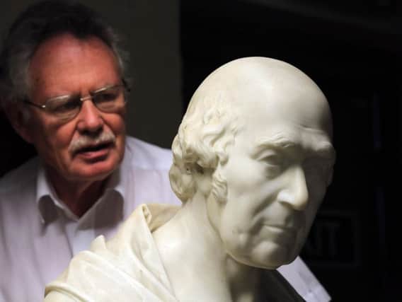 Dr Mike Collins with a bust of one of the hospitals' founding fathers. Picture: Chris Etchells