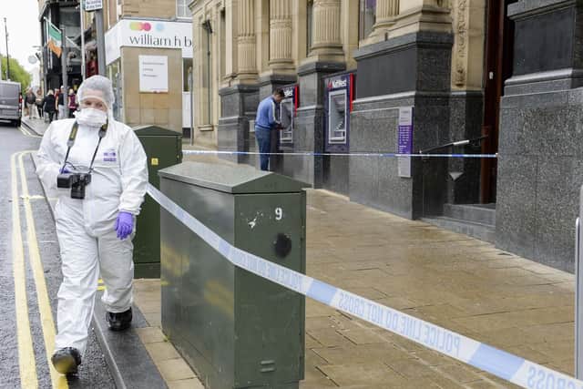 Police investigators cordon off sections of Barnsley town centre after a stabbing.