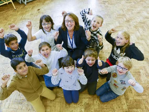 Executive headteacher Sam Fearnehough and pupils at Westways Primary School celebrate the report