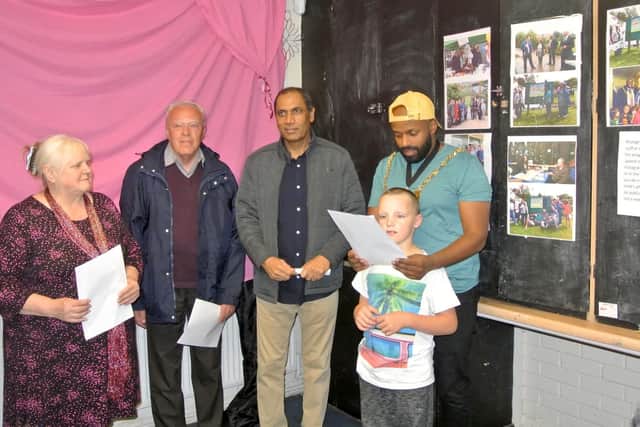 Yanina Koszalinski, chairwoman of Pitsmoor Adventure Playground;Paul Campbell, chairman of Sheffield Green Spaces Forum;CouncillorTalib Hussain; and Lord Mayor Magid Magid with a playground user at the unveiling