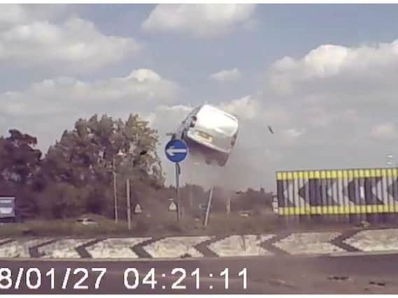 The crazy moment the van flies over the roundabout. Photo: SWNS