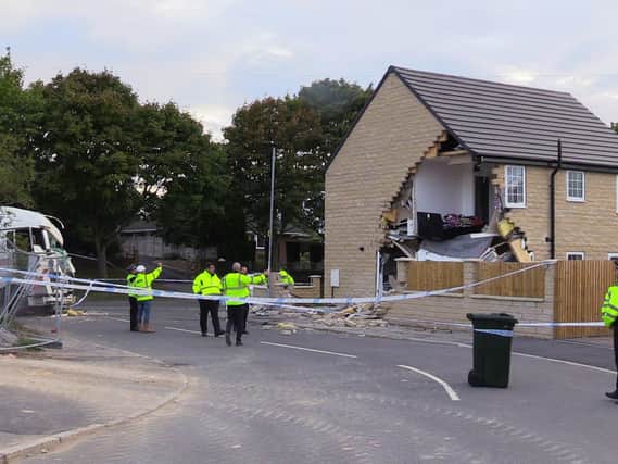 A police cordon in Barnsley, where a house has been left severely damaged after being hit by a lorry. Photo: PA Wire.