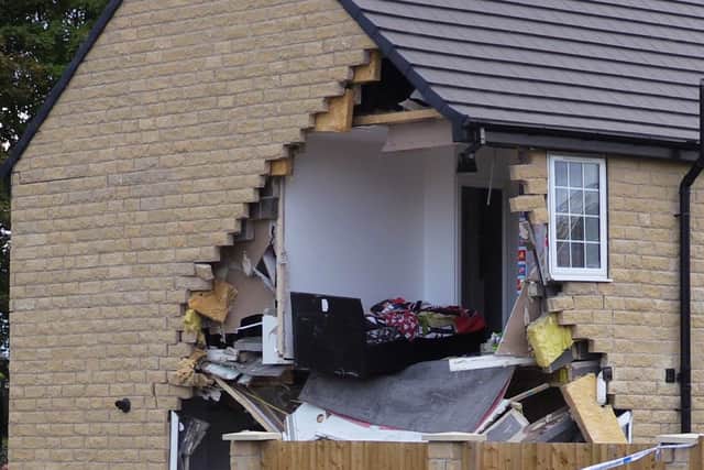 A woman died after being hit by a lorry before it crashed into a house in Barnsley which has been left severely damaged