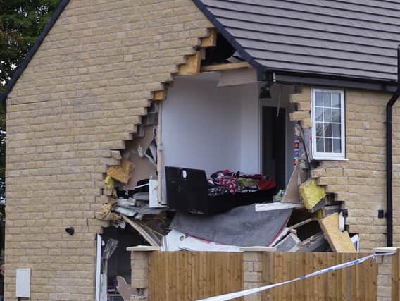A woman died after being hit by a lorry before it crashed into a house in Barnsley which has been left severely damaged