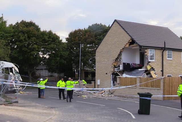 A woman died after being hit by a lorry before it crashed into a house in Barnsley which has been left severely damaged